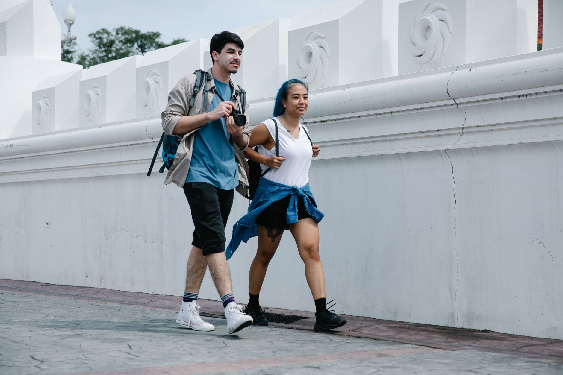 A couple enjoys a city walk together, capturing moments with a camera. — From the City to the Cascades: A Niagara Falls Journ